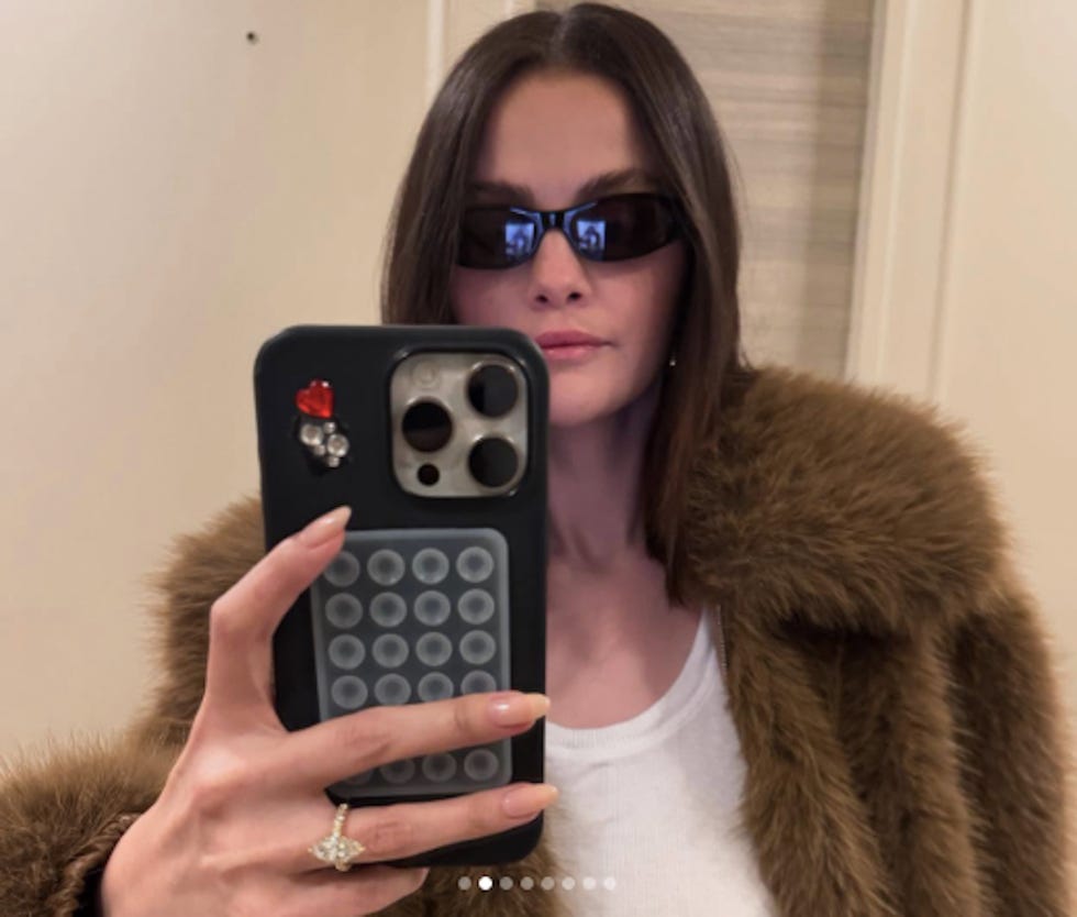 person taking a selfie with a decorated phone case